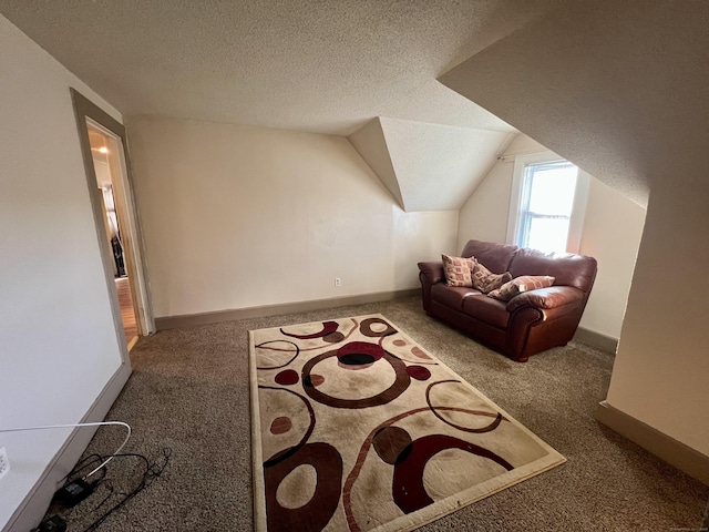 bonus room featuring a textured ceiling, carpet, and lofted ceiling