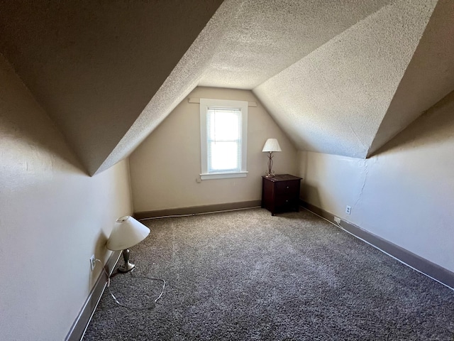 bonus room featuring a textured ceiling, carpet floors, and lofted ceiling