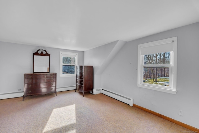 bonus room with carpet flooring, a healthy amount of sunlight, and baseboard heating