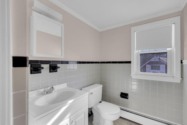 bathroom with vanity, crown molding, tile patterned flooring, tile walls, and a baseboard radiator