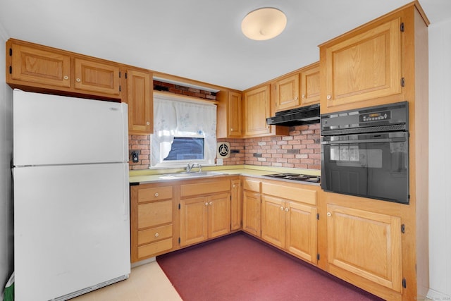 kitchen with sink, stainless steel gas cooktop, white fridge, black oven, and decorative backsplash