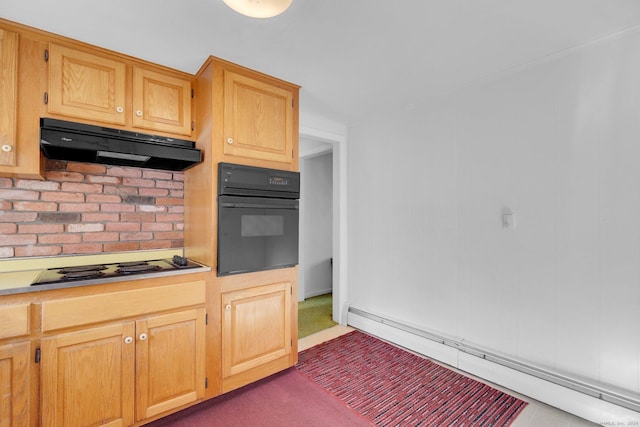 kitchen featuring cooktop, oven, and a baseboard radiator