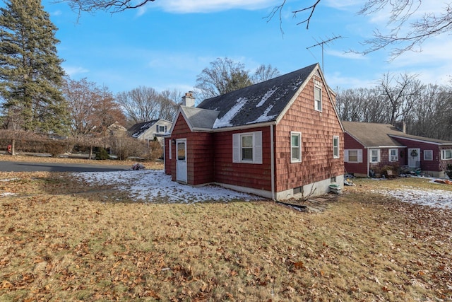 view of property exterior with a lawn