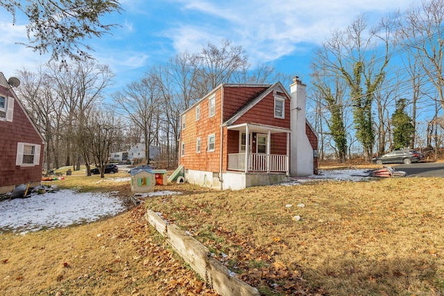 view of side of home with a porch