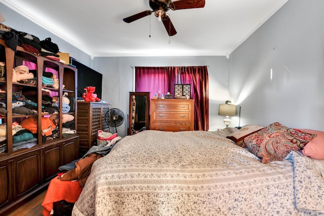 bedroom with hardwood / wood-style flooring, ceiling fan, and crown molding