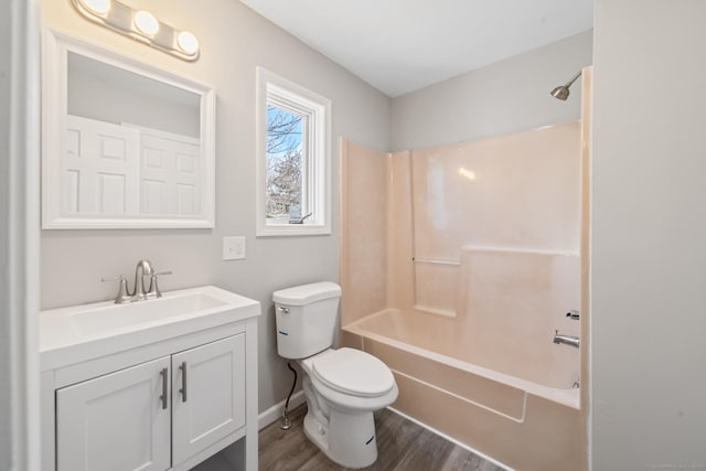 full bathroom featuring vanity, hardwood / wood-style flooring, shower / washtub combination, and toilet