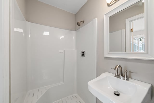 bathroom featuring sink and walk in shower