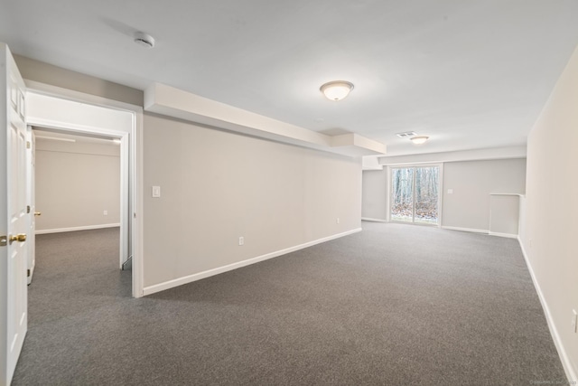 basement featuring dark carpet