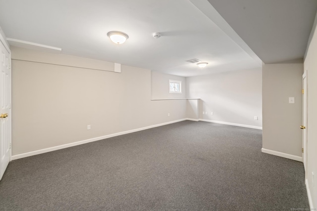 basement featuring dark carpet