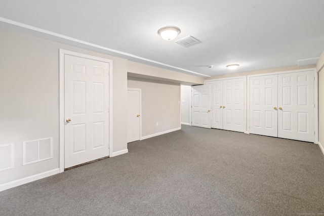 basement featuring dark colored carpet