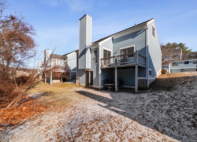 rear view of property with a wooden deck