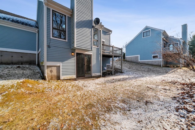 rear view of house featuring a deck