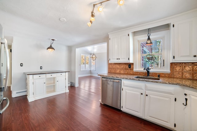 kitchen with stainless steel dishwasher, pendant lighting, white cabinets, and sink