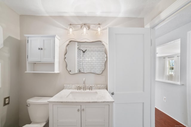 bathroom featuring wood-type flooring, vanity, and toilet