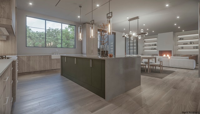 kitchen with a spacious island, hanging light fixtures, light hardwood / wood-style flooring, light brown cabinetry, and a chandelier