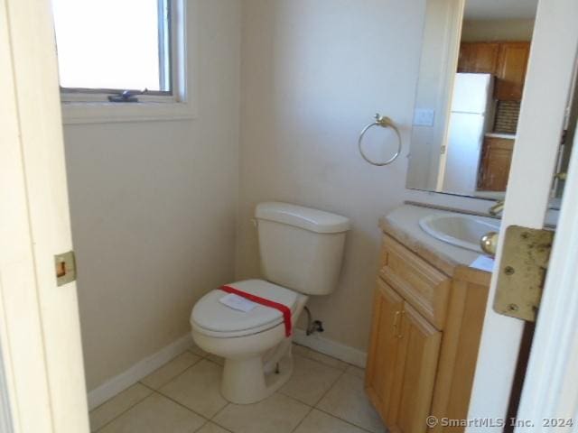 bathroom with tile patterned flooring, vanity, and toilet