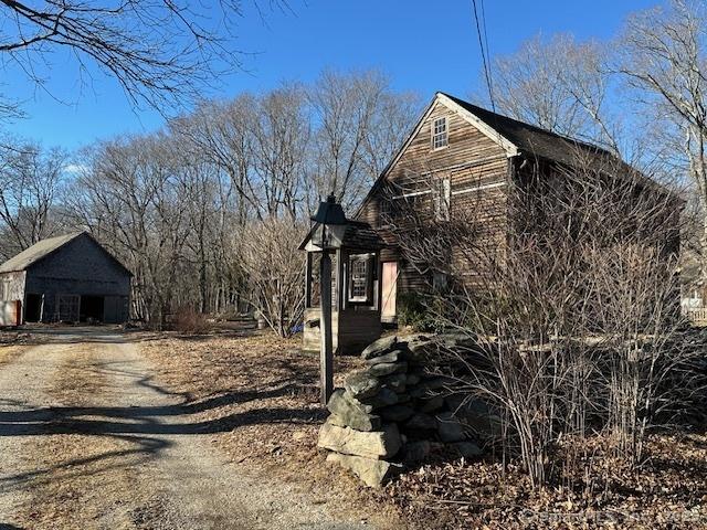 view of property exterior with an outbuilding