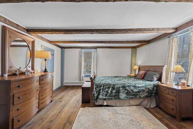 bedroom featuring hardwood / wood-style floors, a baseboard radiator, and beamed ceiling