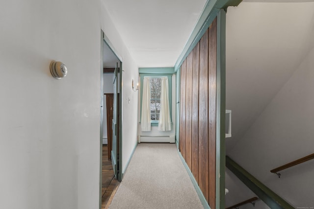 hallway with a baseboard radiator and light carpet