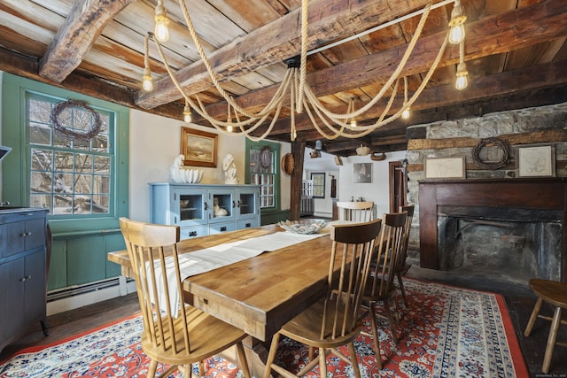 dining area featuring baseboard heating, a fireplace, wood ceiling, and beam ceiling