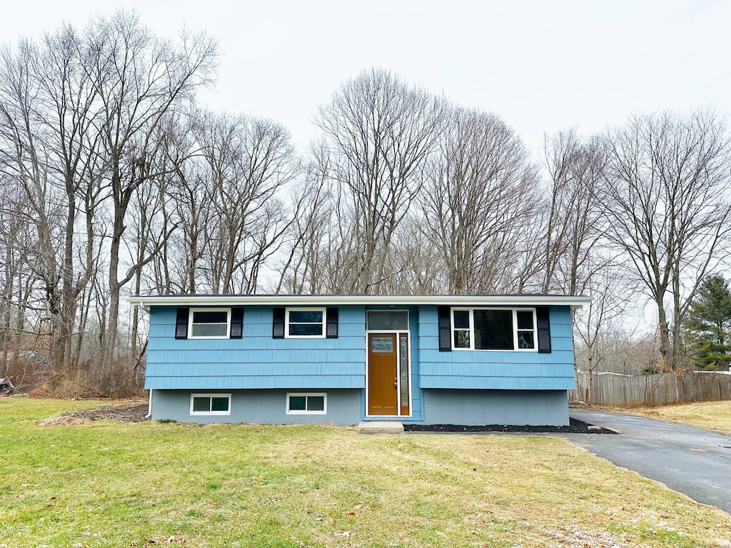 raised ranch featuring a front lawn