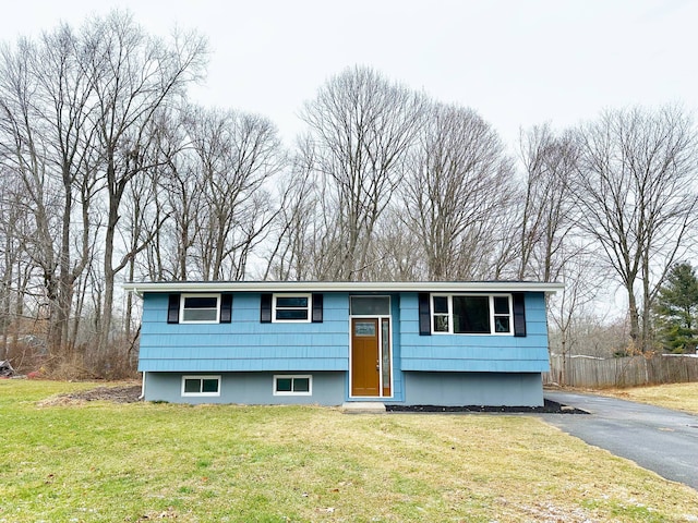 raised ranch featuring a front lawn