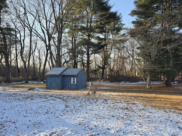 yard covered in snow featuring an outdoor structure