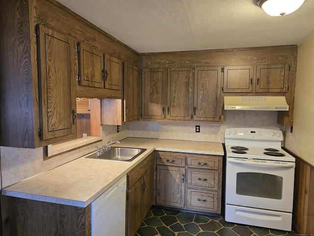 kitchen with a textured ceiling, sink, dark tile patterned floors, and white appliances