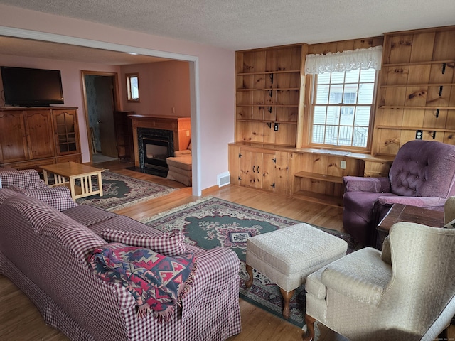 living room featuring hardwood / wood-style floors and a textured ceiling