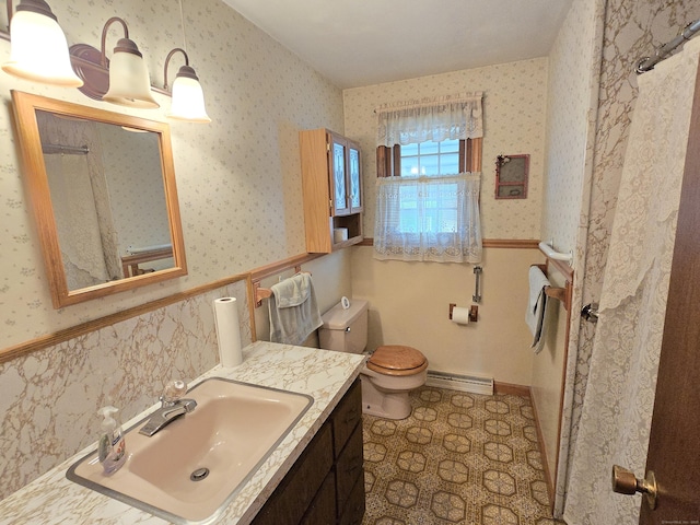 bathroom with vanity, toilet, and a baseboard radiator