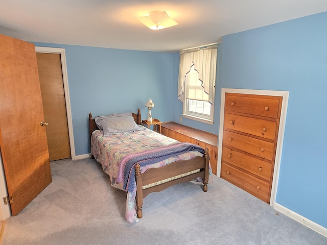 bedroom featuring light carpet