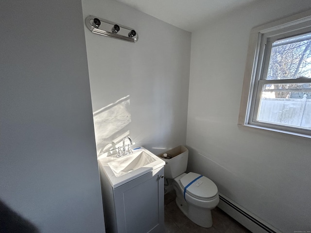 bathroom featuring vanity, a baseboard radiator, and toilet