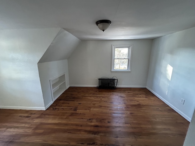 bonus room with dark hardwood / wood-style flooring and lofted ceiling