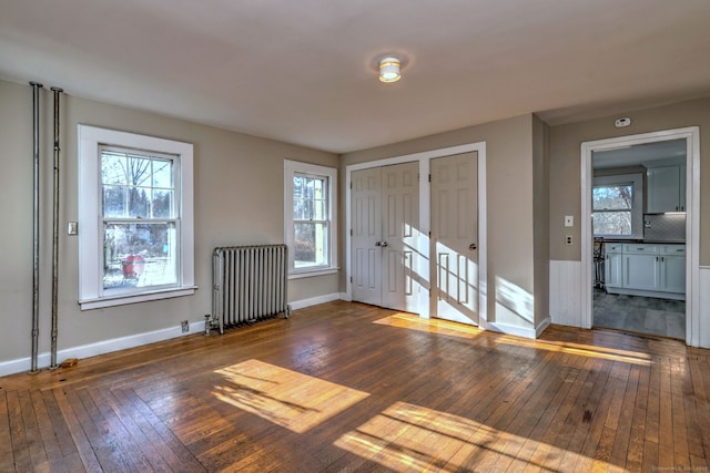 entryway featuring dark hardwood / wood-style floors and radiator