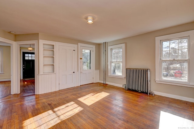 entryway featuring radiator heating unit, a baseboard radiator, and wood-type flooring