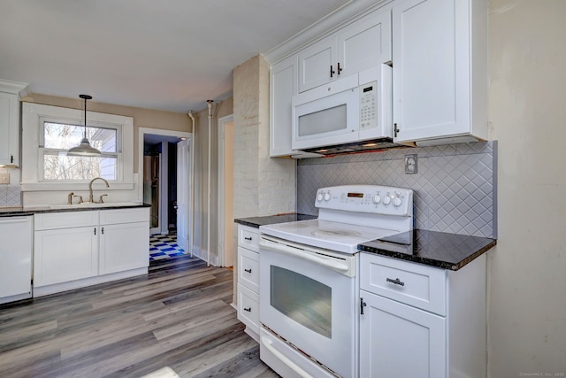 kitchen featuring tasteful backsplash, white appliances, sink, pendant lighting, and white cabinetry