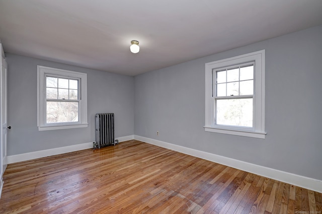 unfurnished room with light wood-type flooring and radiator