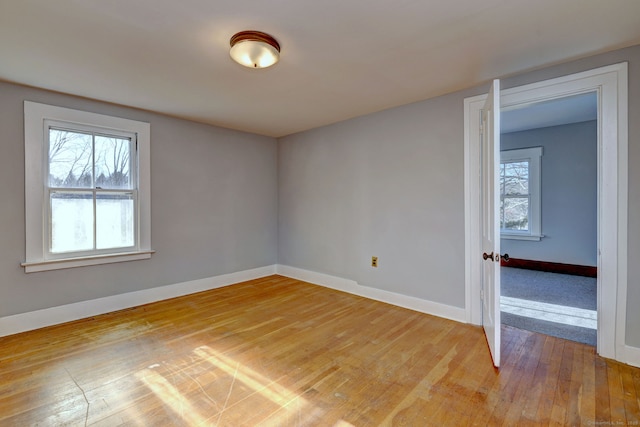 unfurnished room with light hardwood / wood-style floors