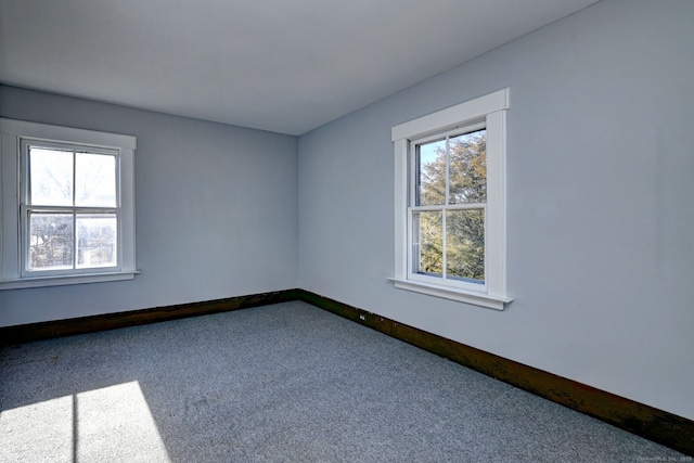 carpeted empty room featuring plenty of natural light