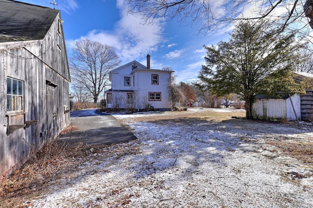 back of house featuring an outbuilding