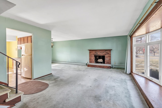 unfurnished living room featuring stairway, carpet, and a baseboard radiator