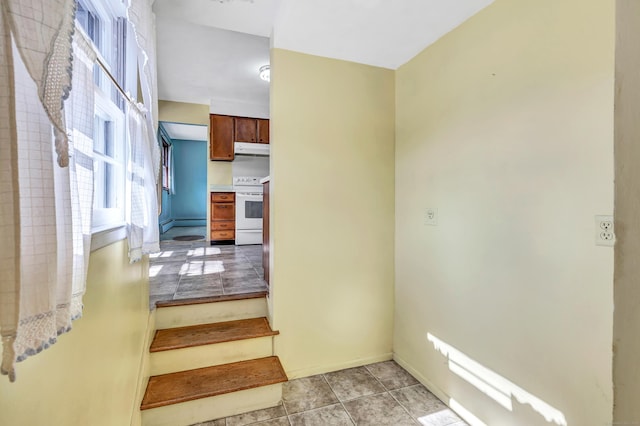 staircase with tile patterned flooring, baseboards, and baseboard heating