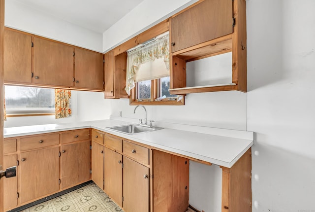 kitchen featuring a sink, light floors, and light countertops