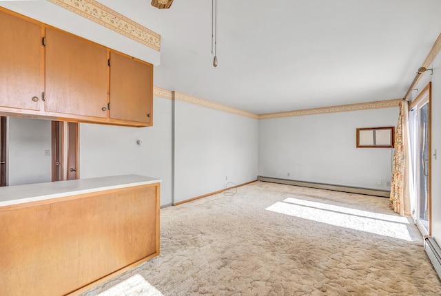 interior space featuring light carpet, light countertops, baseboards, and a baseboard radiator