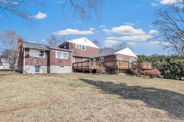 back of house with a wooden deck, a lawn, a chimney, and stairway