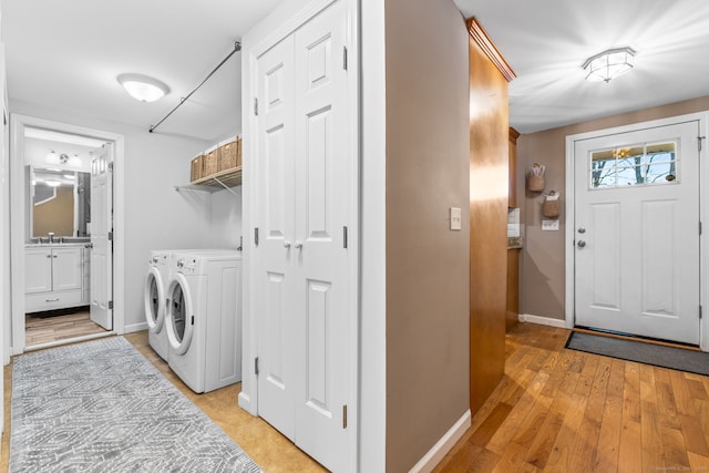 washroom featuring light wood-type flooring and separate washer and dryer