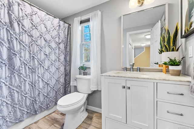 bathroom featuring hardwood / wood-style flooring, vanity, toilet, and a shower with shower curtain