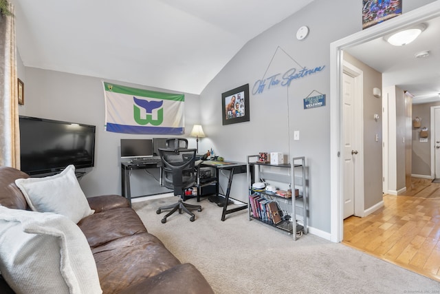 carpeted office with vaulted ceiling