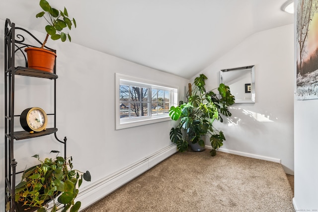 living area with baseboard heating, carpet floors, and vaulted ceiling