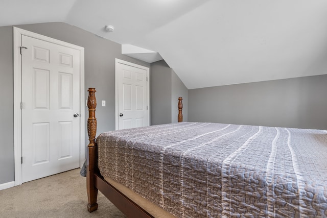 bedroom with carpet and vaulted ceiling